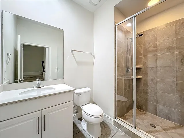 an empty room with closet and a bathroom