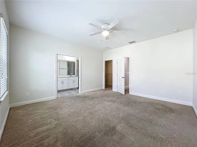 an aerial view of a house with a yard and lake view
