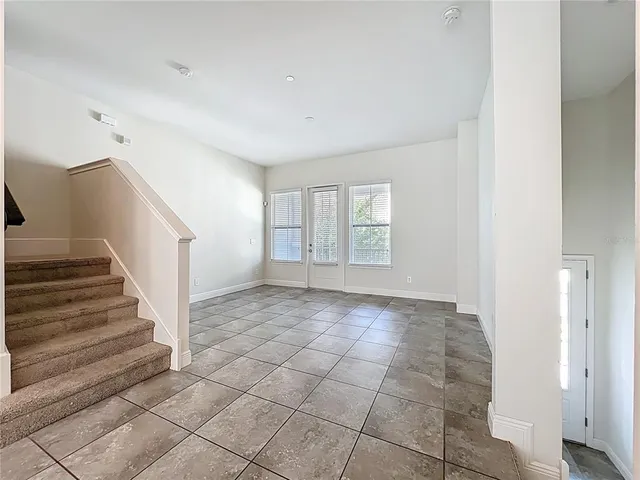 a view of kitchen with granite countertop cabinets and window