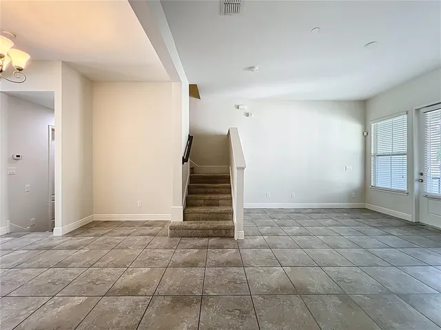 a kitchen with stainless steel appliances granite countertop a sink and a refrigerator