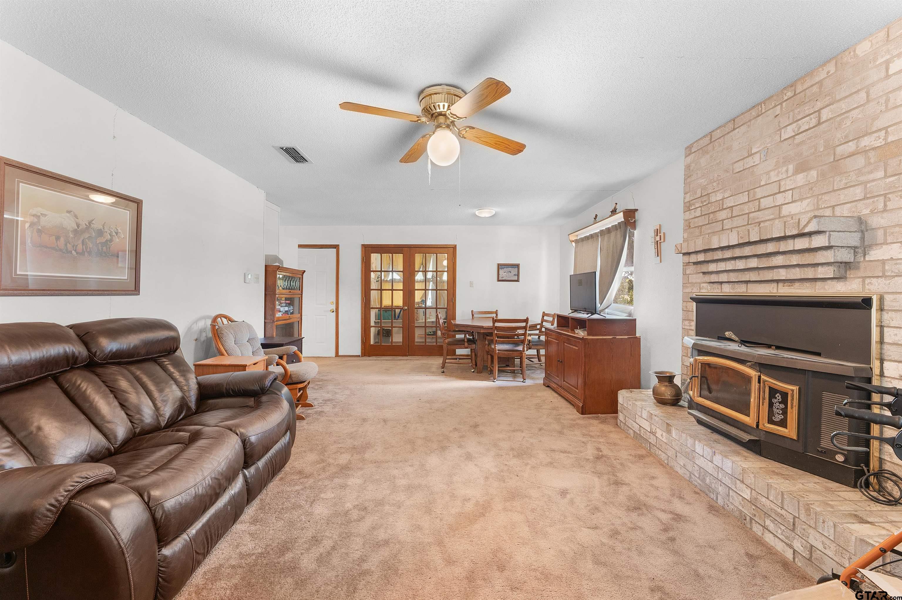 226 County Road 3533 Saltillo, TX 75478 - Photo 11 of 36 a living room with furniture a window and a flat screen tv
