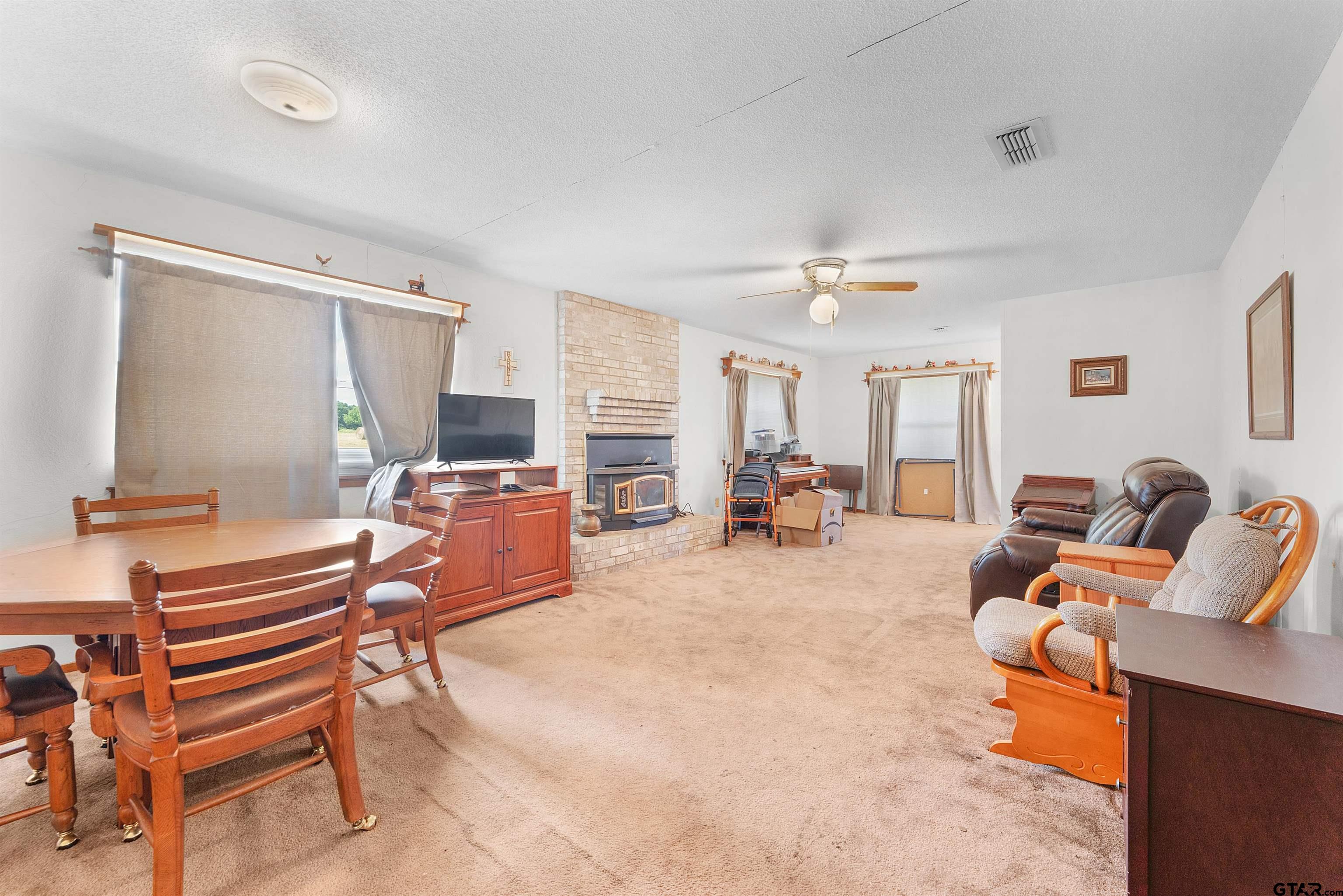 226 County Road 3533 Saltillo, TX 75478 - Photo 12 of 36 a living room with furniture a flat screen tv and a window