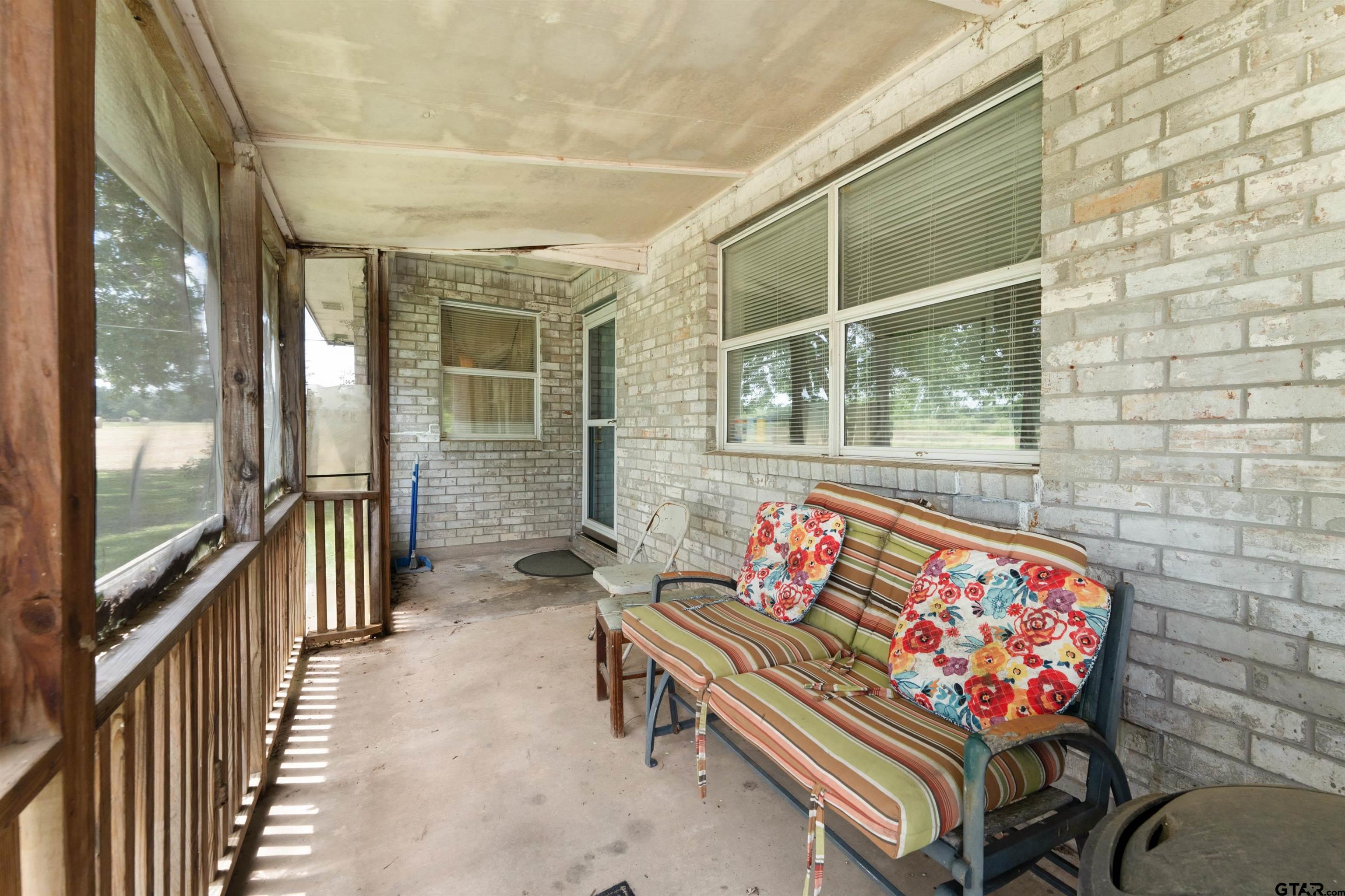 226 County Road 3533 Saltillo, TX 75478 - Photo 2 of 36 a outdoor living space with furniture and a potted plant