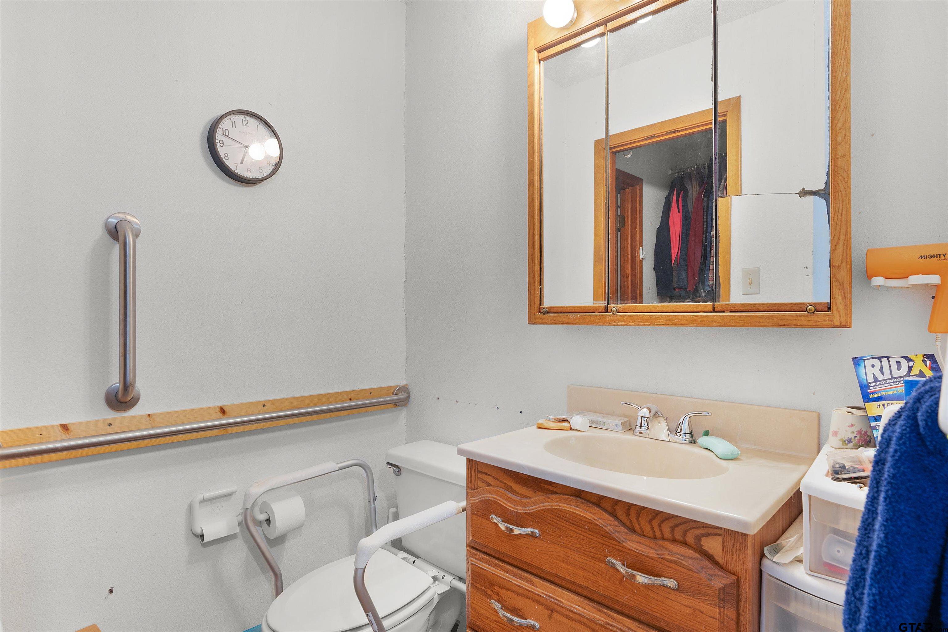 226 County Road 3533 Saltillo, TX 75478 - Photo 24 of 36 a bathroom with a sink and a mirror