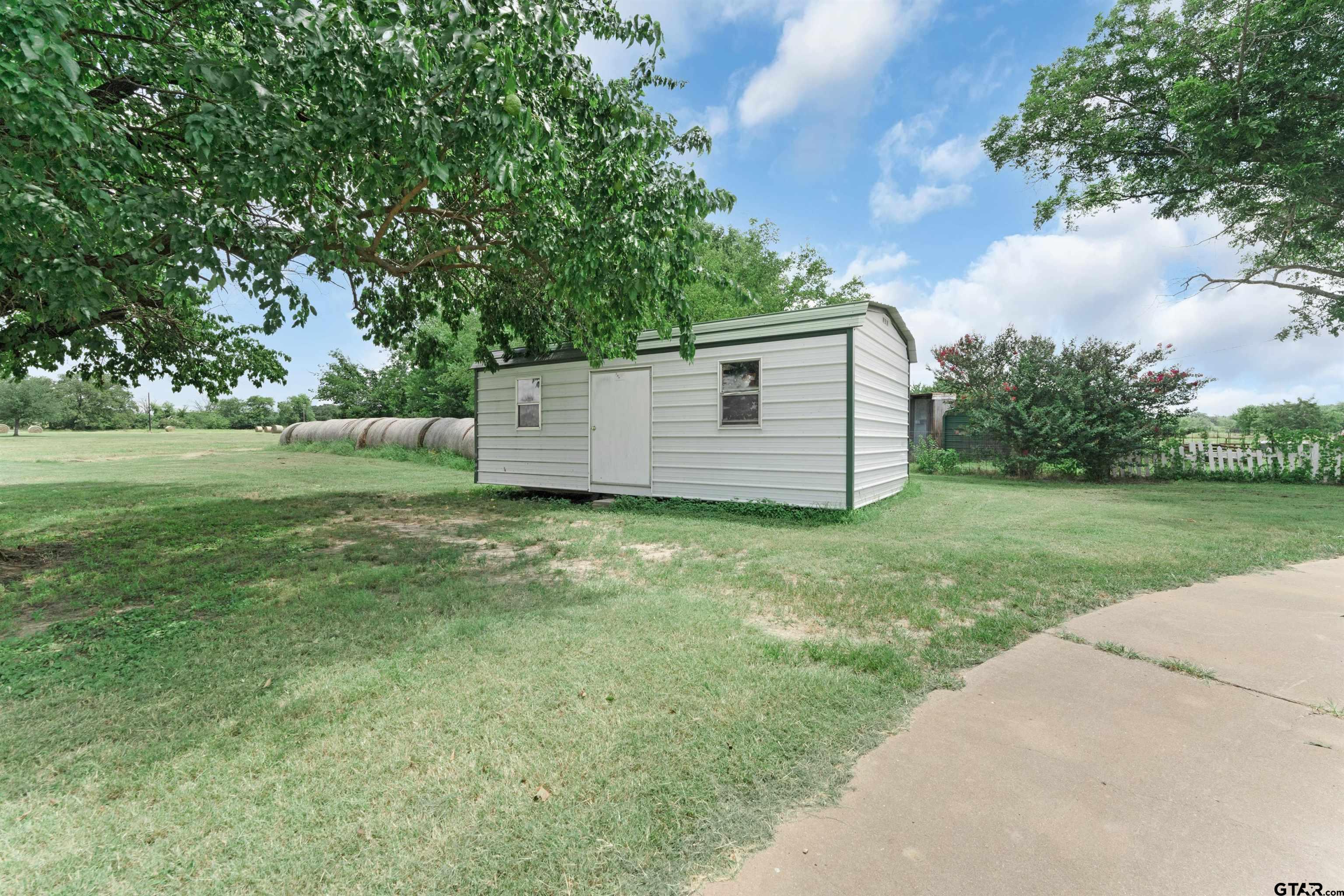 226 County Road 3533 Saltillo, TX 75478 - Photo 8 of 36 a view of a backyard with barn and large trees