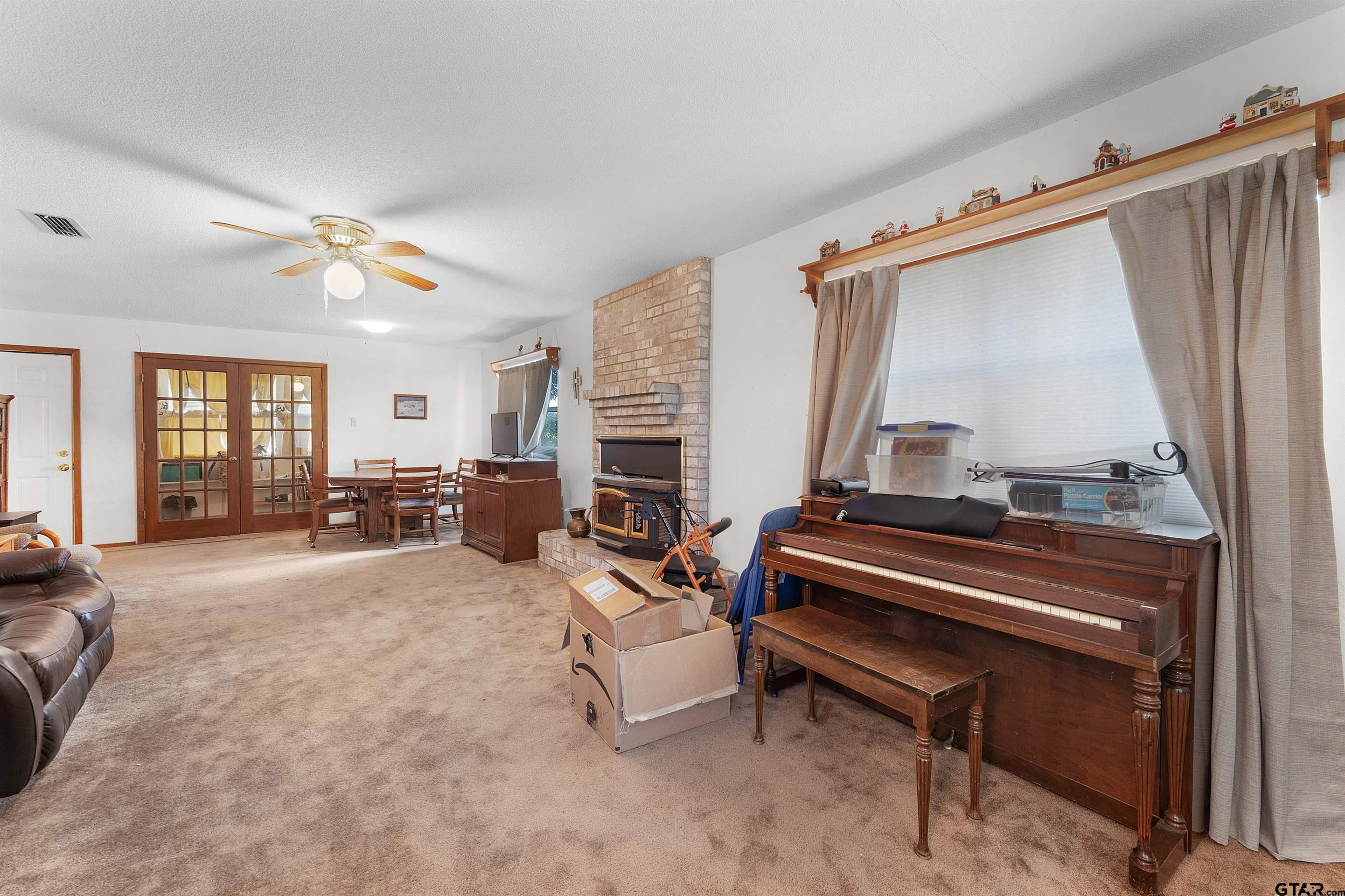 226 County Road 3533 Saltillo, TX 75478 - Photo 10 of 36 a living room with furniture a piano and a flat screen tv
