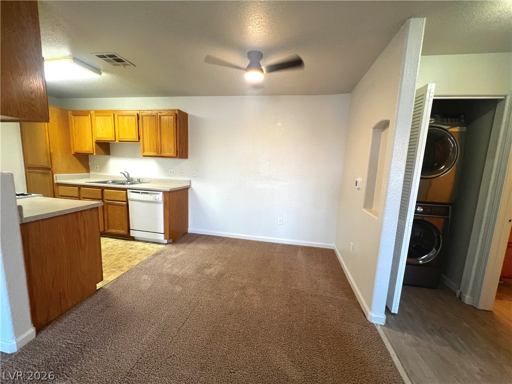 4730 East Craig Road, Unit 2104 Las Vegas, NV 89115 - Photo 3 of 20 Functional kitchen with ample cabinetry and essential appliances offers convenient laundry access nearby.