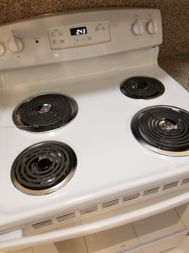 1663 Southeast 27th Drive, Unit 202 Homestead, FL 33035 - Photo 11 of 16 a close view of a stove and washer