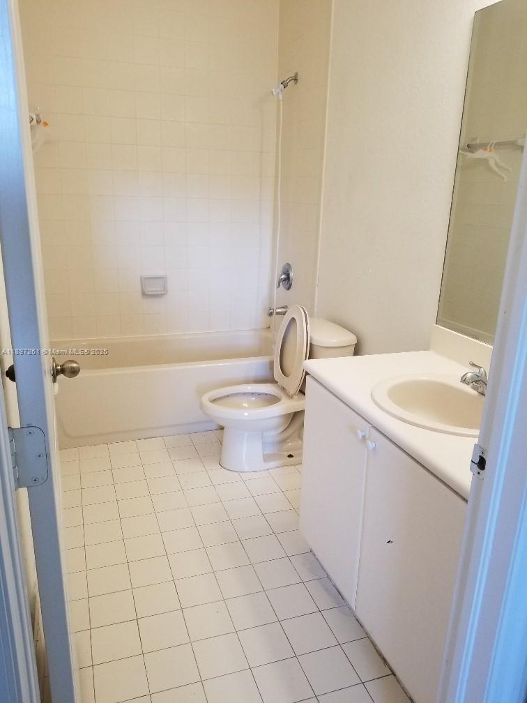 1663 Southeast 27th Drive, Unit 202 Homestead, FL 33035 - Photo 6 of 16 a bathroom with a sink a toilet and shower