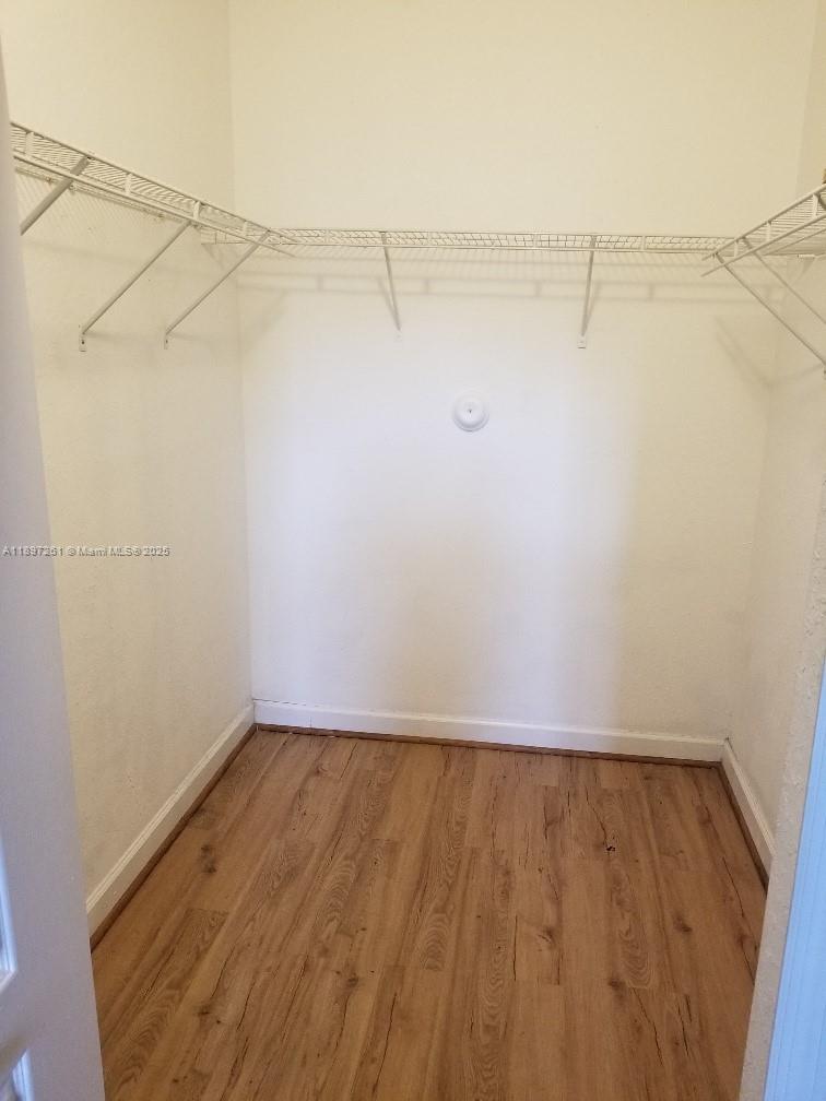 1663 Southeast 27th Drive, Unit 202 Homestead, FL 33035 - Photo 7 of 16 a view of a room with racks on the wall