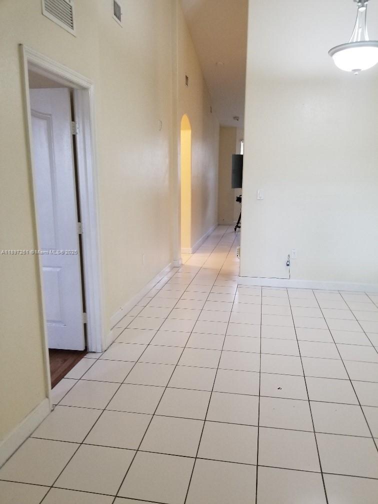1663 Southeast 27th Drive, Unit 202 Homestead, FL 33035 - Photo 8 of 16 a view of an empty room and a bathroom
