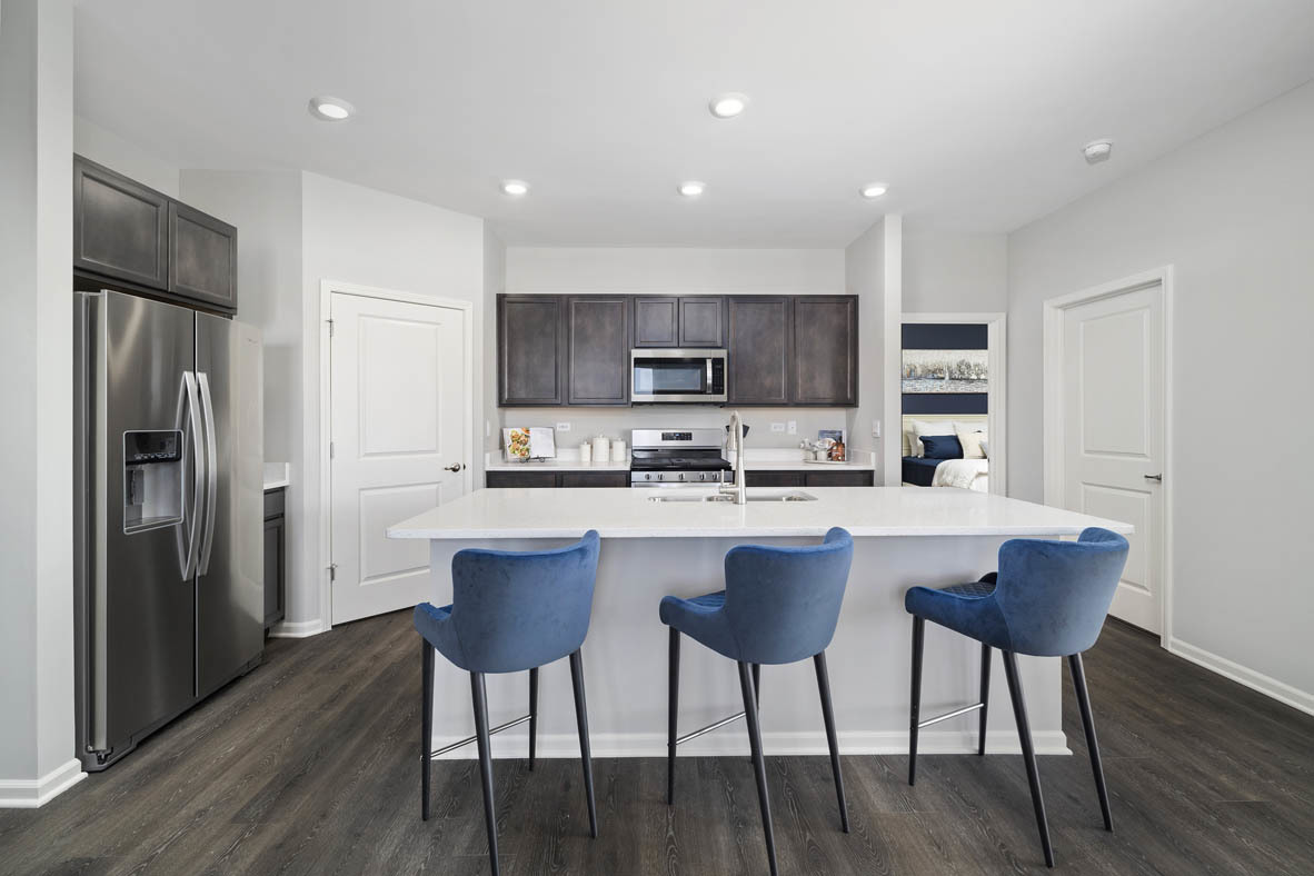 920 Eineke Boulevard Algonquin, IL 60102 - Photo 5 of 27 a kitchen with stainless steel appliances granite countertop a center island a stove a refrigerator and a dining table with wooden floor