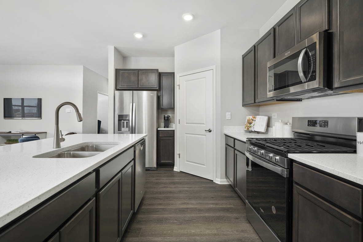 920 Eineke Boulevard Algonquin, IL 60102 - Photo 8 of 27 a kitchen with stainless steel appliances granite countertop a sink stove microwave and refrigerator
