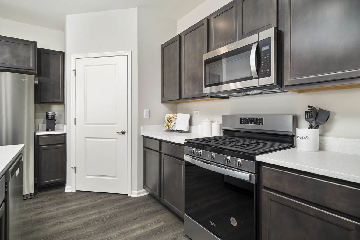 920 Eineke Boulevard Algonquin, IL 60102 - Photo 9 of 27 a kitchen with stainless steel appliances granite countertop a stove microwave and refrigerator