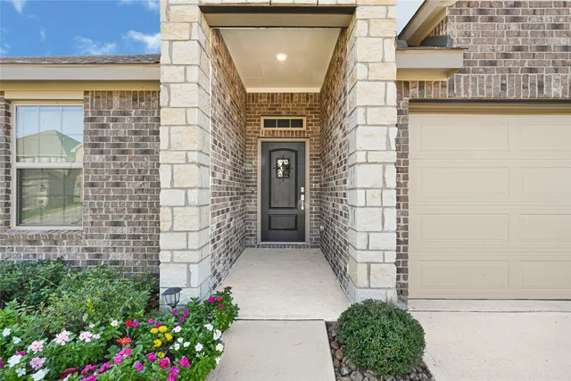 a front view of a house with a yard and flowers