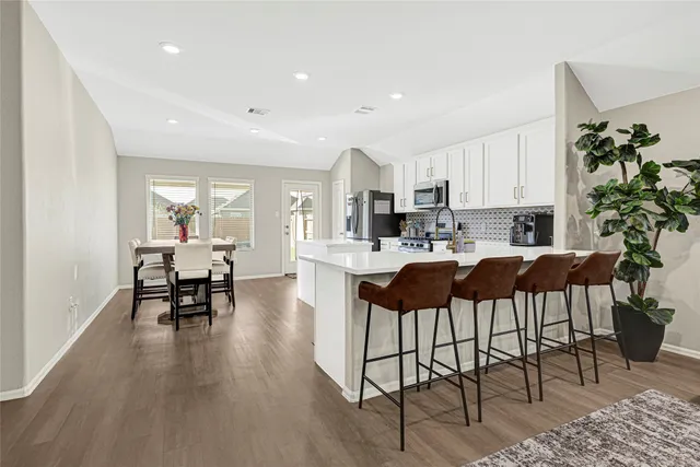 a kitchen with a dining table and chairs