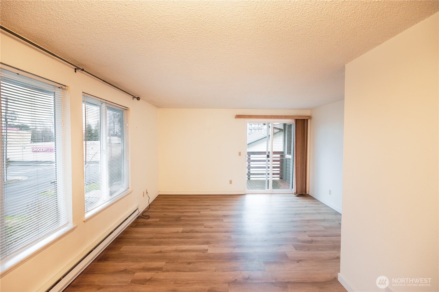 1534 Franklin Street Bellingham, WA 98225 - Photo 3 of 6 a view of an empty room with wooden floor and a window