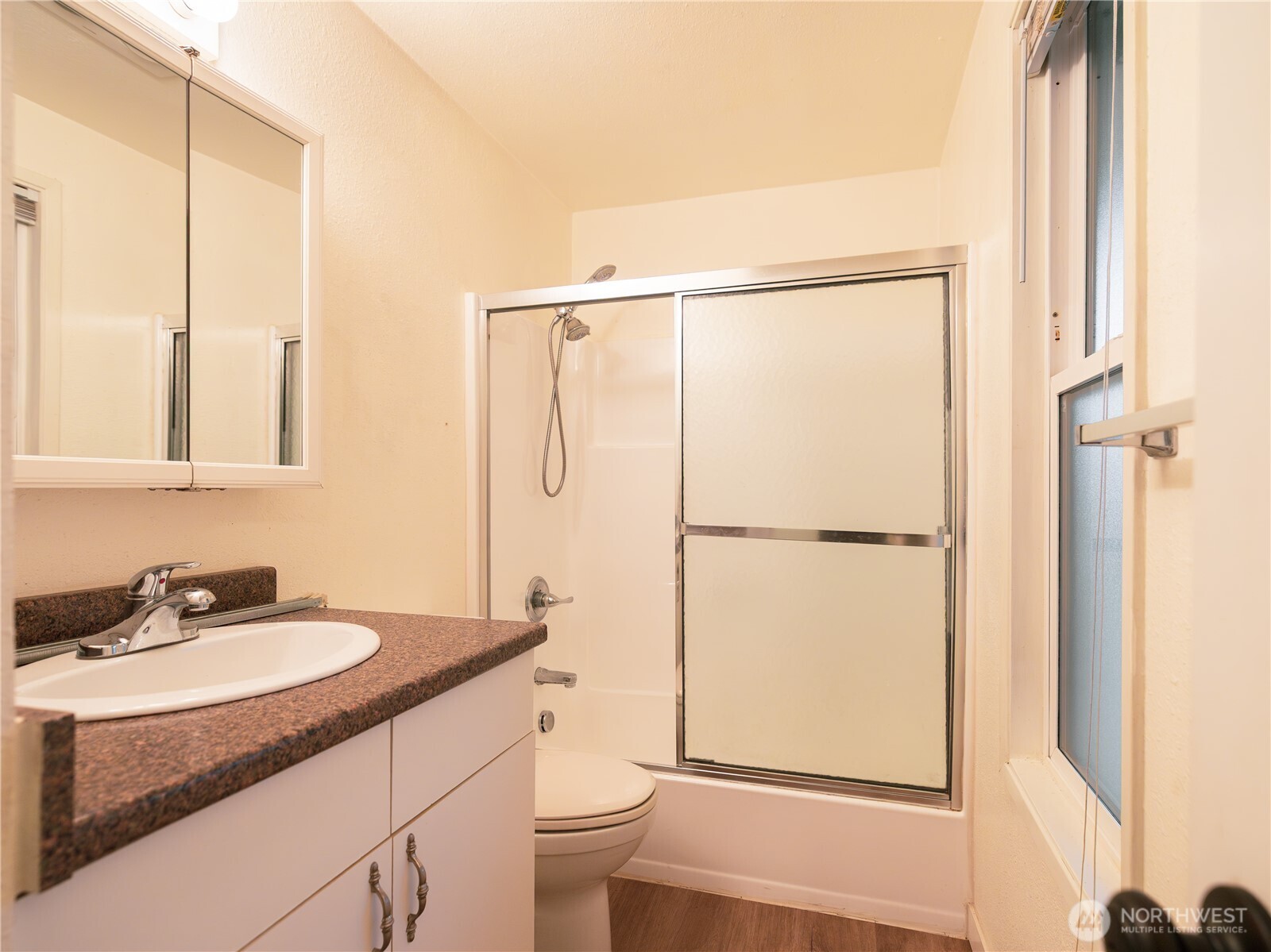 1534 Franklin Street Bellingham, WA 98225 - Photo 4 of 6 a bathroom with a granite countertop sink toilet and shower