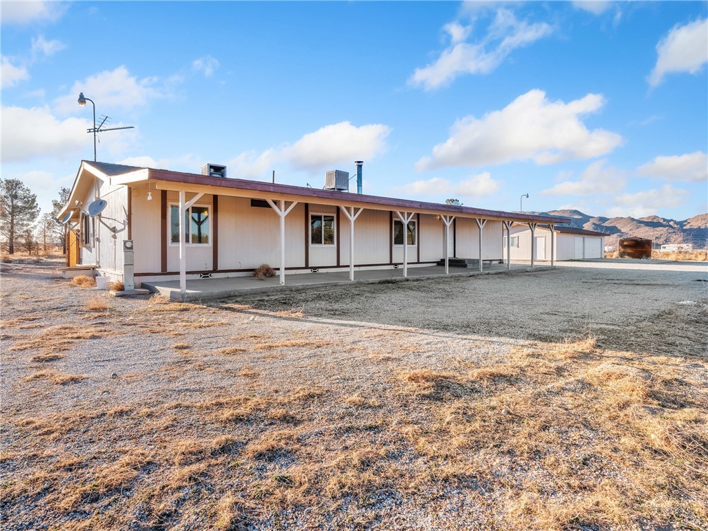 11078 High Road Lucerne Valley, CA 92356 - Photo 1 of 1 a front view of a house with a yard