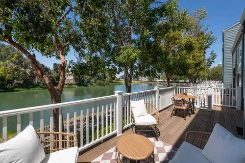 a view of a balcony with lake view and wooden floor