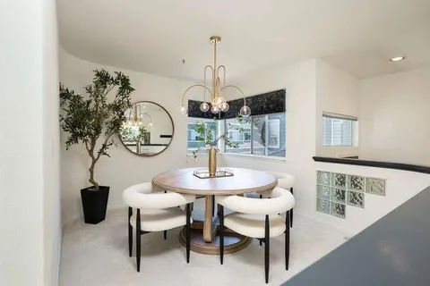a dining room with furniture and a chandelier