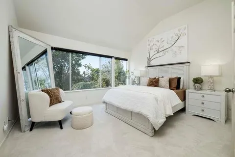 a bed room with furniture and a large window