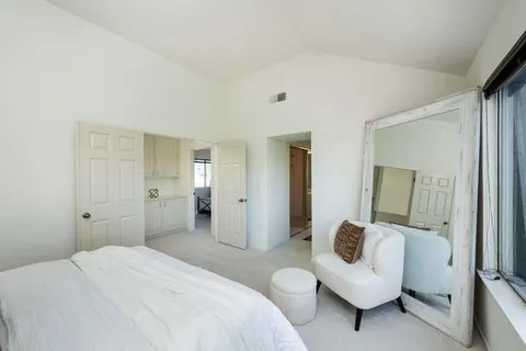 a spacious bedroom with a bed and a couch