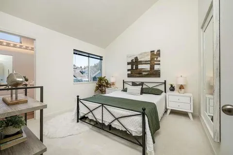 a room with a bed and a table in it