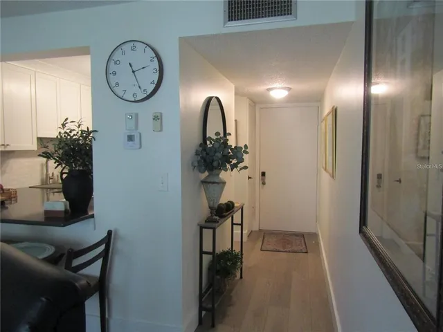 a kitchen with granite countertop white cabinets and stainless steel appliances