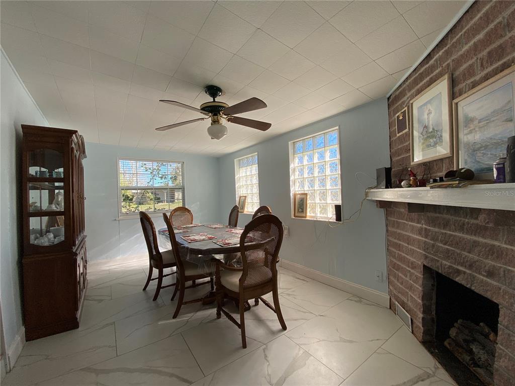 910 Lake Avenue Edgewater, FL 32132 - Photo 8 of 23 a dining room with furniture and window