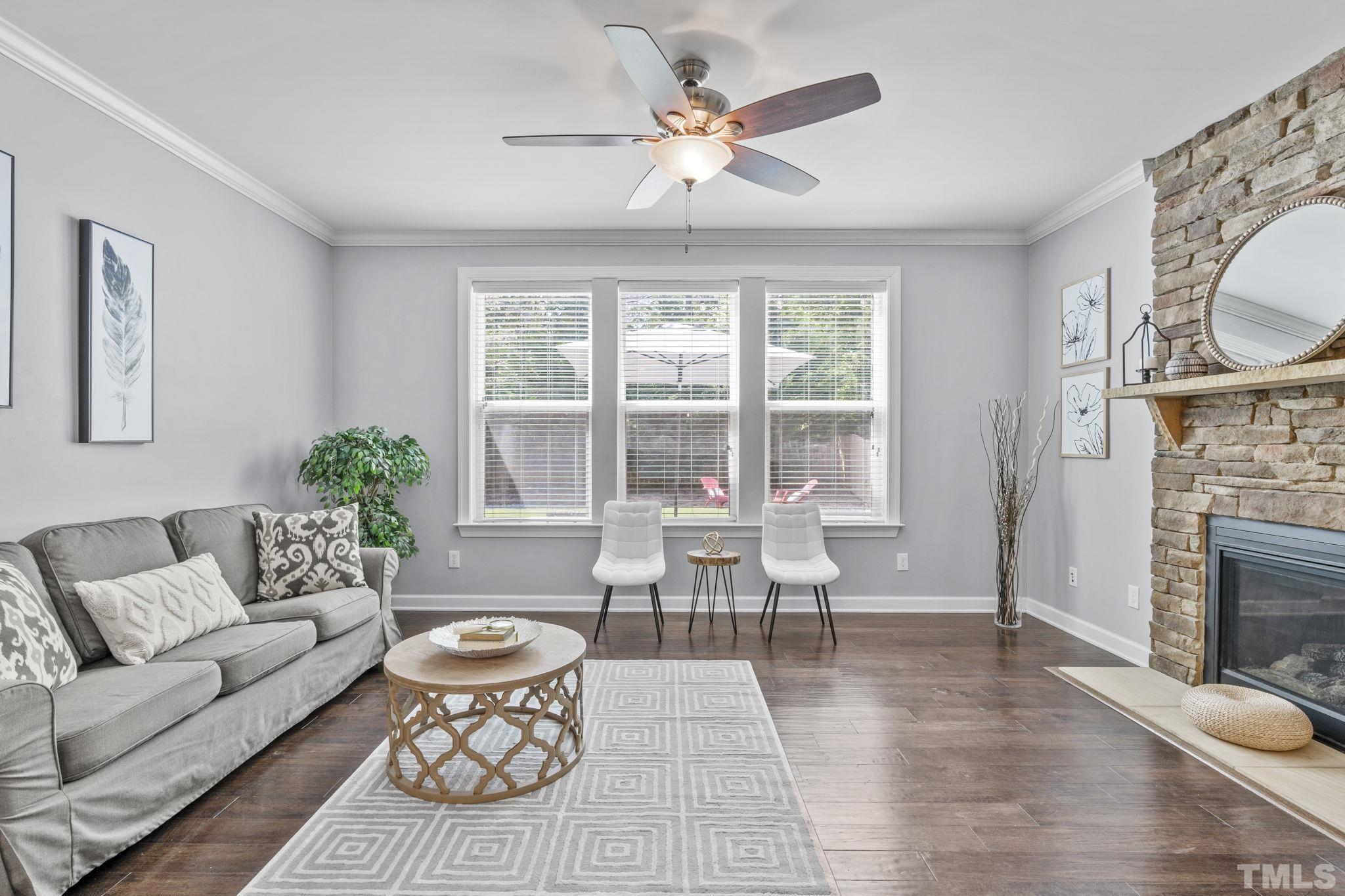 2039 Travern Drive Raleigh, NC 27603 - Photo 11 of 40 a living room with furniture a fireplace and a table