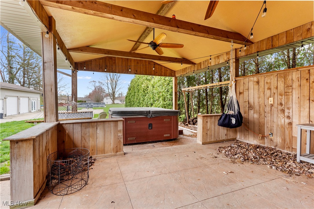 4075 Kirk Road Austintown, OH 44511 - Photo 7 of 40 View of patio / terrace with fence, a ceiling fan, and a hot tub