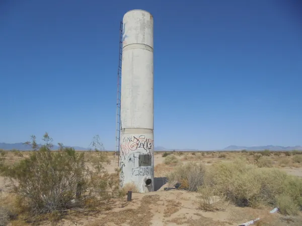 a water fountain in the middle of a field