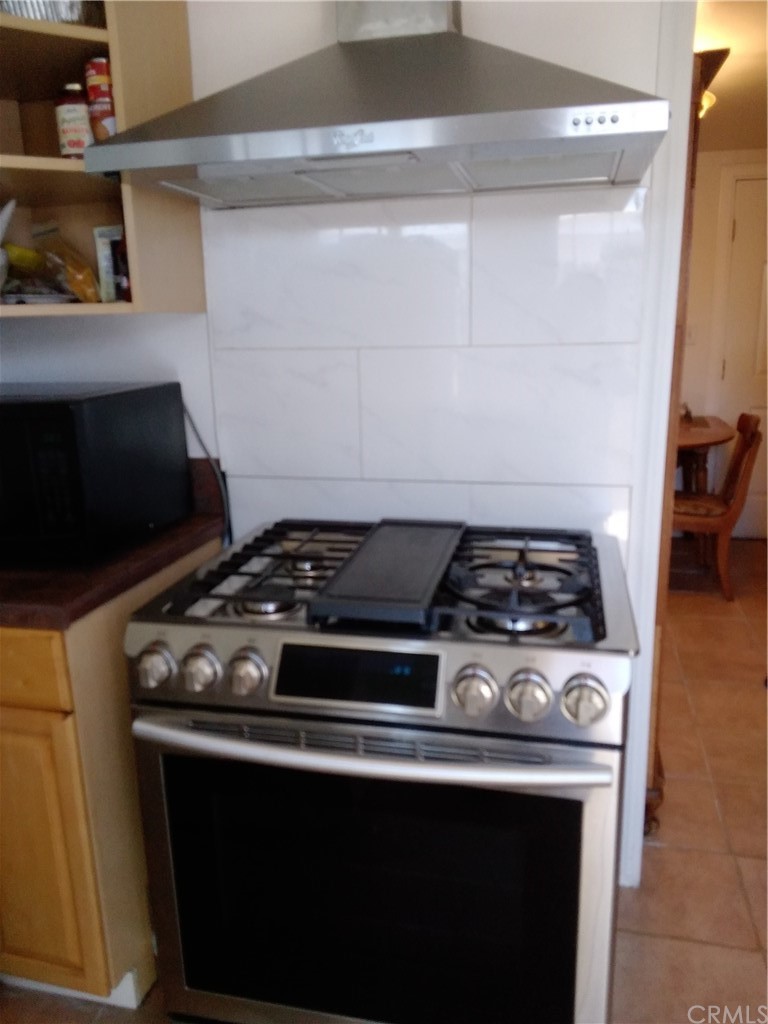 12101 Hermosura Street Norwalk, CA 90650 - Photo 14 of 20 a stove top oven sitting inside of a kitchen
