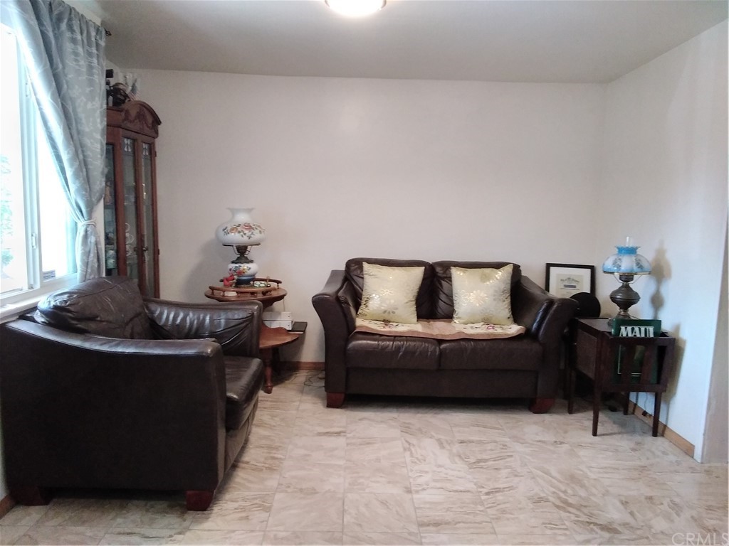 12101 Hermosura Street Norwalk, CA 90650 - Photo 7 of 20 a living room with furniture and a fireplace