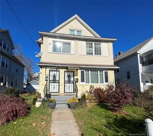a front view of a house with a yard