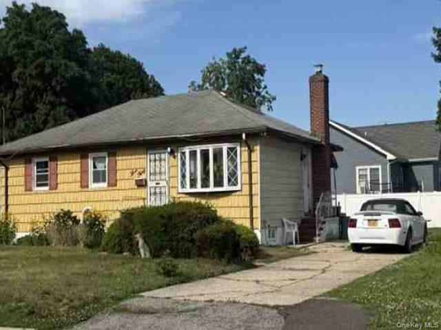 330 Amerigo Vespucci Avenue Copiague, NY 11726 - Photo 2 of 3 a car parked in front of a house