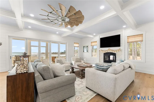 a living room with furniture fireplace and a large window