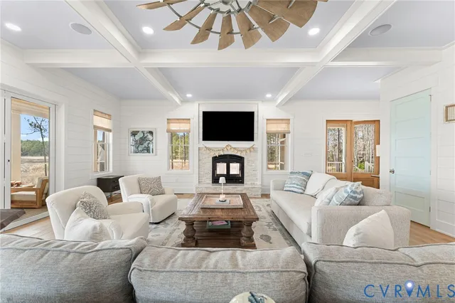 a living room with furniture a fireplace and a flat screen tv