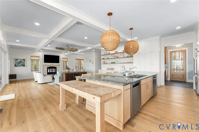 a large kitchen with stainless steel appliances granite countertop a stove oven and a wooden cabinets