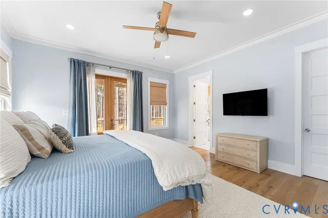 a bedroom with a bed a flat screen tv and a couch