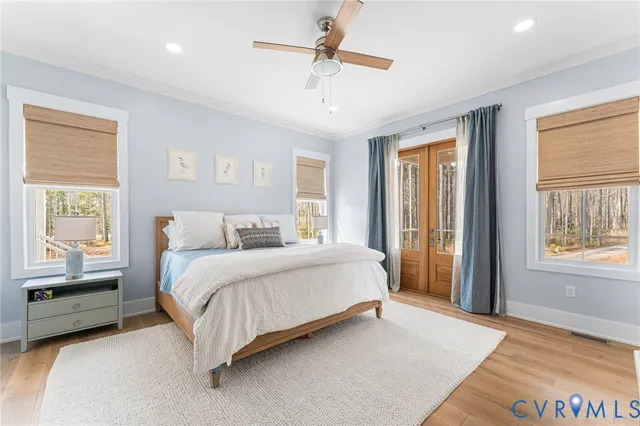 a spacious bedroom with a bed a chandelier and a window