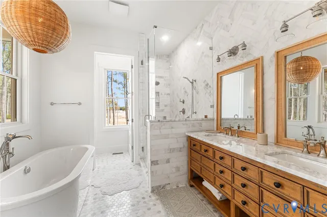 a bathroom with a granite countertop sink mirror and bathtub