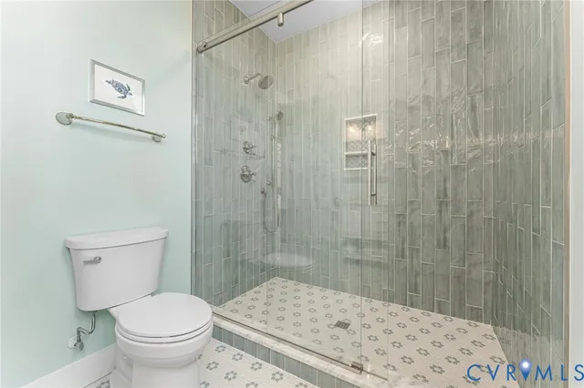 a bathroom with a shower and a toilet