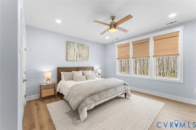 a bedroom with a large bed and a window