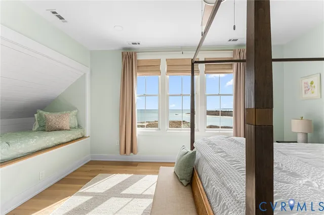 a spacious bedroom with a large bed and a large window