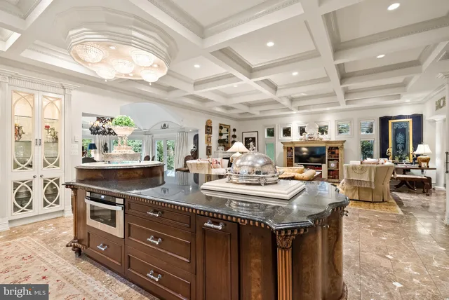 a living room with patio furniture and a chandelier