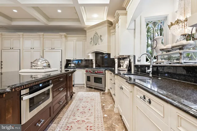 a living room with patio furniture and a chandelier