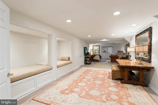 a living room with furniture a chandelier and a flat screen tv