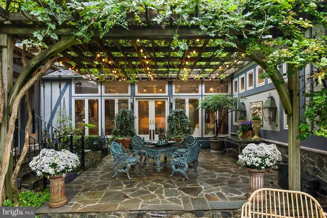 a kitchen with a stove a sink a dining table and chairs